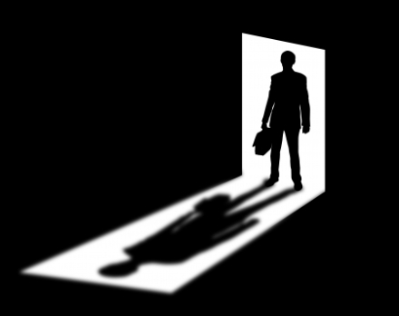 18476681 - silhouette of coming businessman in doorway with shadow